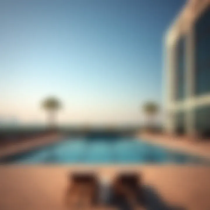 Sophisticated outdoor pool area with lounge chairs at Hayli Rotana
