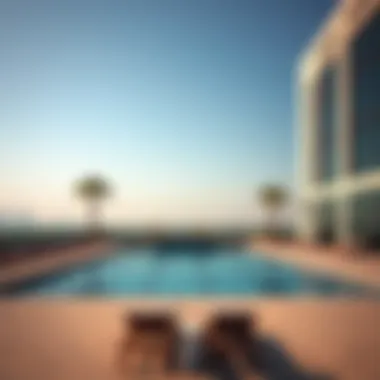 Serenity in Luxury: The Outdoor Pool at Hayli Rotana Sophisticated outdoor pool area with lounge chairs at Hayli Rotana