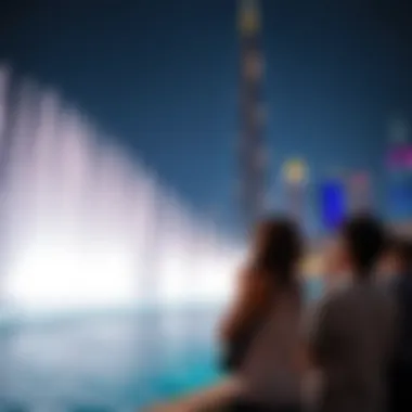 Spectators Admiring the Fountain Against the Skyline Spectators enjoying the fountain performance against the Dubai skyline